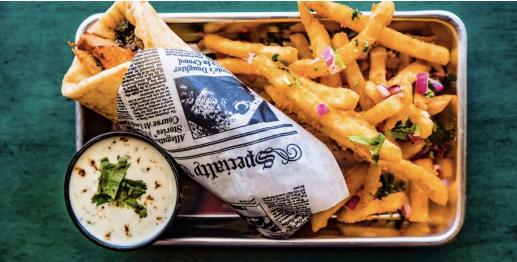 Plated naan wraps and fries served at Malika